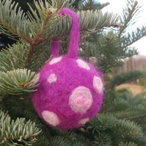 Hand felted Christmas Tree Ball Ornaments by Hillary Dow, Made in Maine, pictured in a tree farm