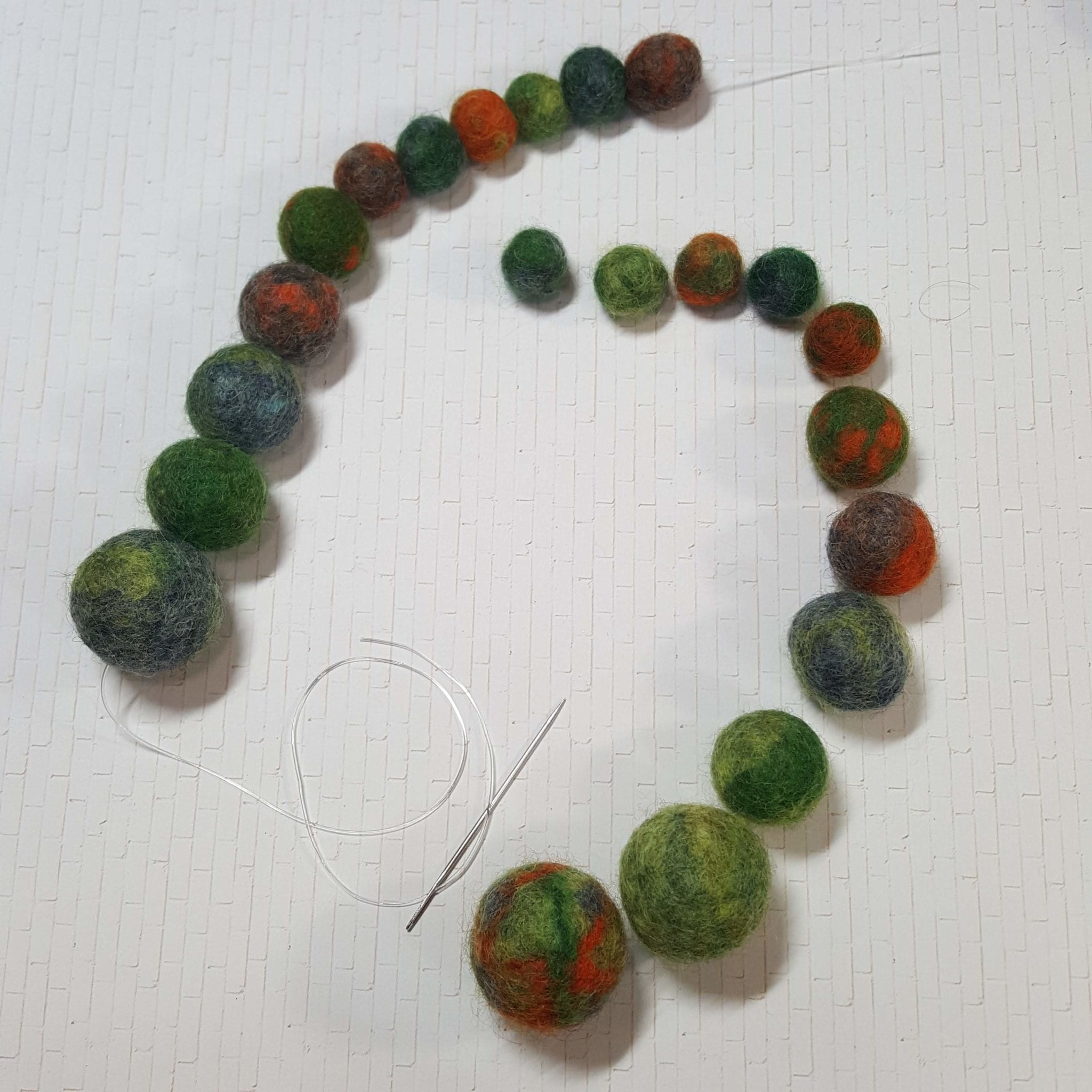 wet and needle felting wool beads stringing a wool bead necklace