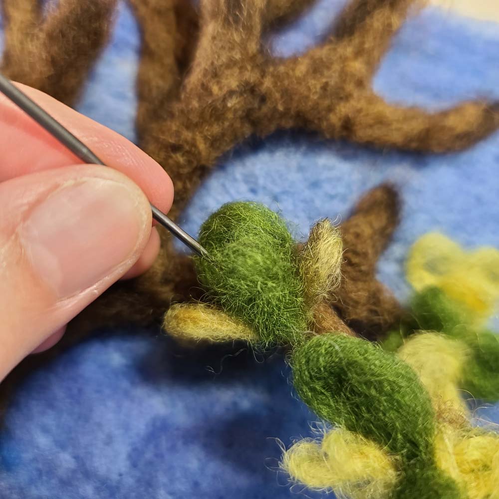 Needle Felting a sunny yard with a flower bed Needle felting leaves on trees, instructor Hillary Dow