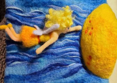 Sun Fairy Flies Into the Sun, the appearance of motion is created by needle felting intentional lines of color with wool.