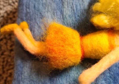 To bend the legs at the knee use your felting needle on the backside of the knee. The more you felt the back of the bend, the more angle you will create.