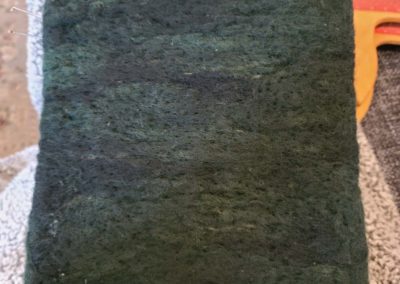 Felting a black sky begins with a dark base.